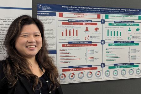 Dr. Stephanie Cheng smiling in front of a poster.